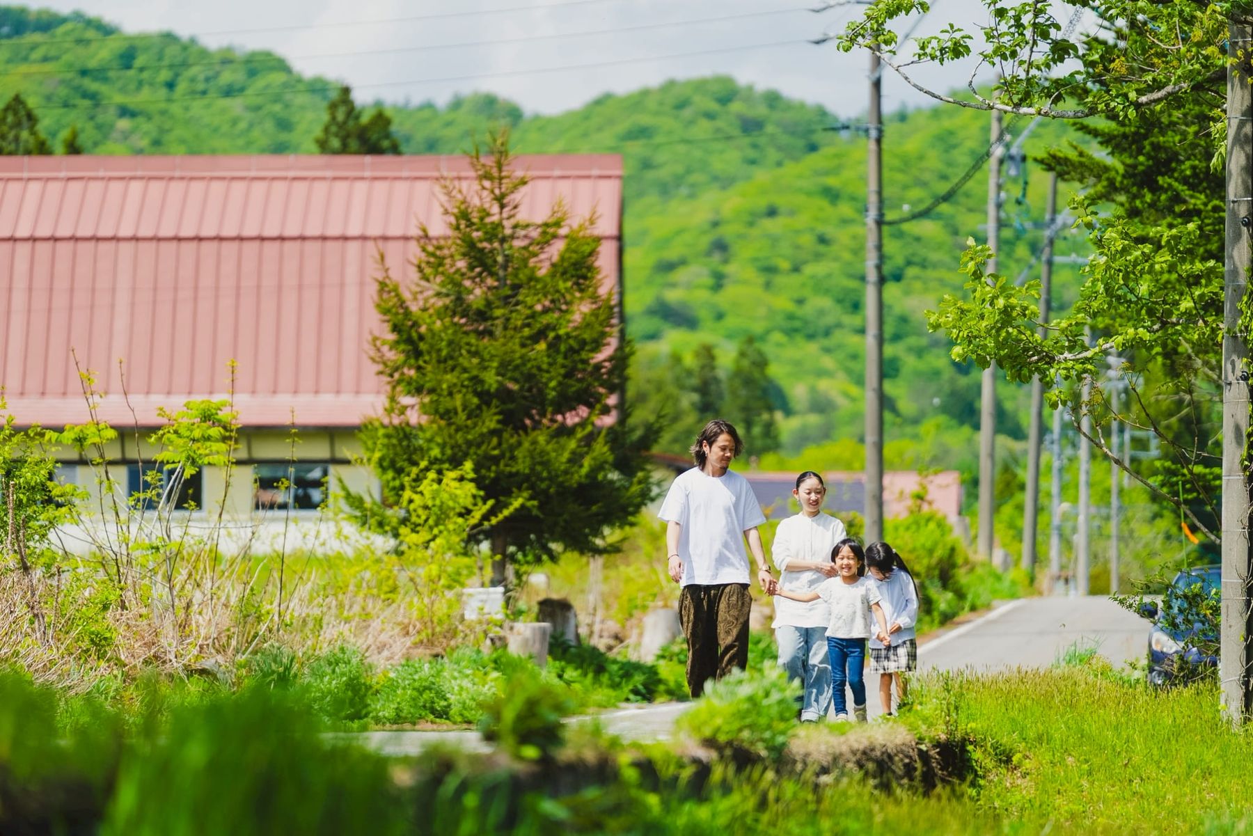 里山の小径を歩く家族